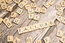 Scrabble game with failure word on a table.
