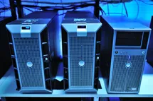 A photo of there desktop computers in a data center rack shelf.