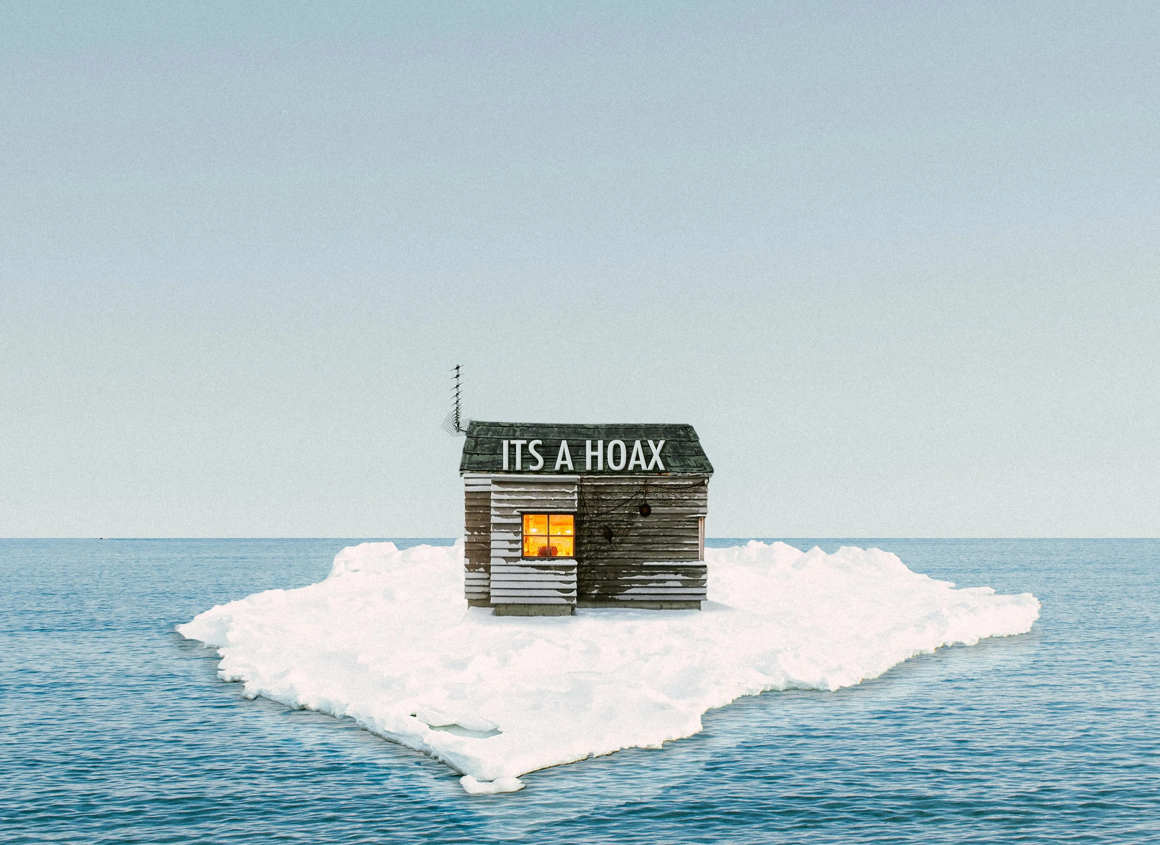 A house on a small island with a sign saying its a hoax