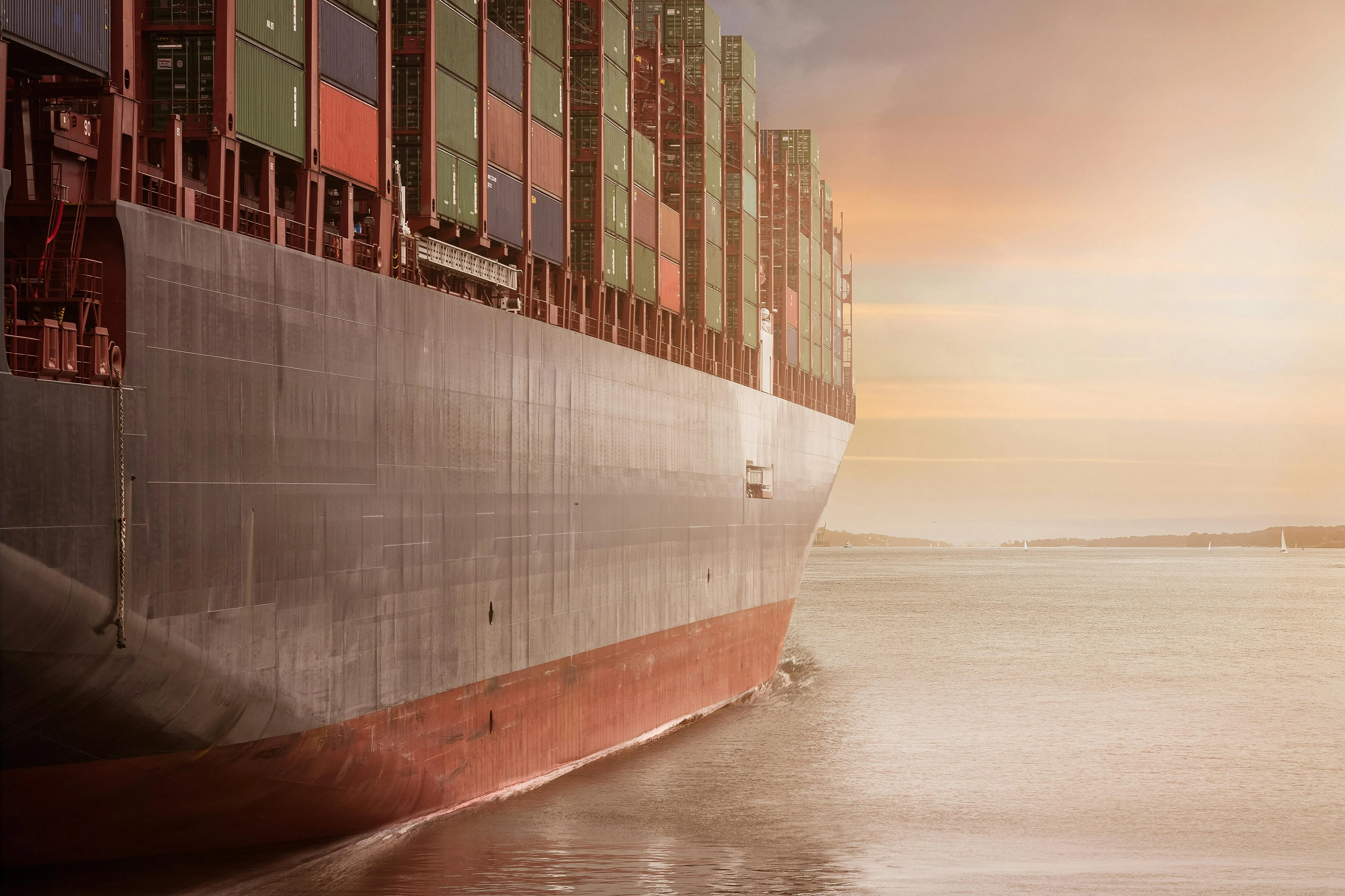 A photo taken from the right side of a big container ship.
