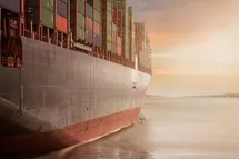 A photo taken from the right side of a big container ship.