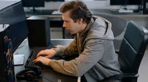 Software dev coding with confused face.