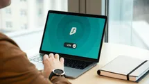 A person using a laptop and connecting to a vpn service.